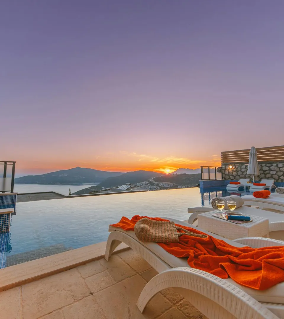 Luxury infinity pool terrace overlooking the sea at sunset